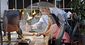 Young African American businesswoman assists biracial woman in office