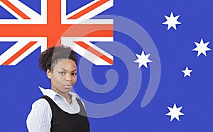 Young African American businesswoman smiling over Australian flag