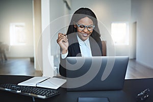 Young African American businesswoman smiling while working on a