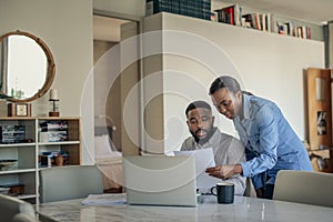 Young African American couple doing their online banking at home