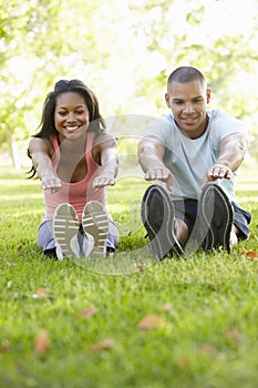 Young African American Couple Exercising In Park