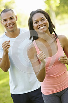 Young African American Couple Jogging In Park