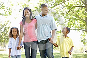 Young African American Family Enjoying Walk In Park