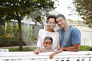 Young African American family outside their new house