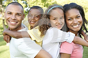 Young African American Family Relaxing In Park