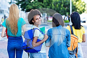 Young african american female student with group of friends