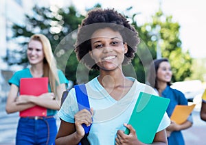 Young african american female student with group of women