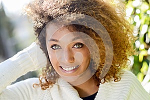 Young African American girl with afro hairstyle and green eyes