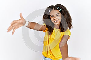 Young african american girl standing over white isolated background looking at the camera smiling with open arms for hug