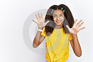 Young african american girl standing over white isolated background showing and pointing up with fingers number ten while smiling