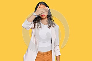 Young african american girl wearing business clothes covering eyes with hand, looking serious and sad