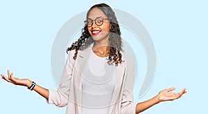 Young african american girl wearing business clothes smiling showing both hands open palms, presenting and advertising comparison photo