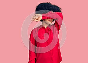 Young african american girl wearing casual clothes covering eyes with arm, looking serious and sad