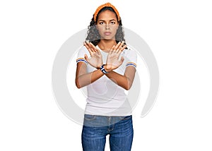 Young african american girl wearing casual clothes rejection expression crossing arms doing negative sign, angry face