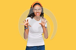 Young african american girl wearing casual clothes smiling funny doing claw gesture as cat, aggressive and sexy expression