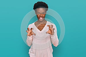 Young african american girl wearing casual clothes smiling funny doing claw gesture as cat, aggressive and sexy expression