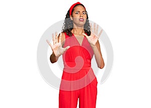 Young african american girl wearing elegant and sexy look afraid and terrified with fear expression stop gesture with hands,