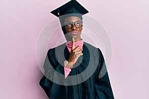 Young african american girl wearing graduation cap and ceremony robe thinking concentrated about doubt with finger on chin and