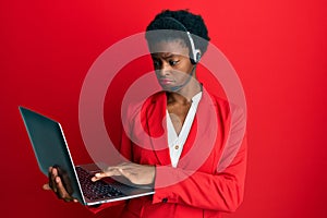 Young african american girl working at the office wearing operator headset depressed and worry for distress, crying angry and