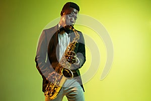 Young african-american jazz musician playing the saxophone