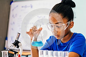 Young African American kid doing chemistry experiment