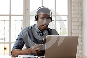 Young african american male employee holding video call.