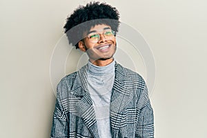 Young african american man with afro hair wearing casual clothes  glasses looking to side, relax profile pose with natural face