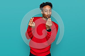 Young african american man with beard wearing casual winter sweater doing money gesture with hands, asking for salary payment,