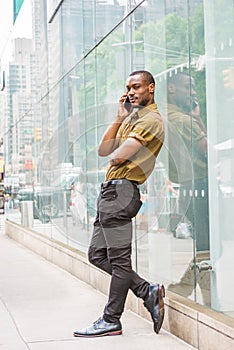 Young African American Man calling on cell phone on street in Ne