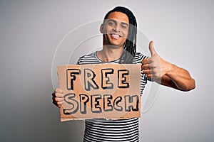 Young african american man with dreadlocks holding banner with free speech message protest happy with big smile doing ok sign,