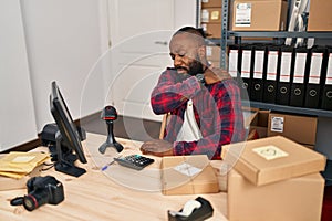 Young african american man ecommerce business worker suffering for backache at office
