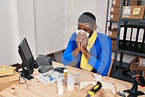 Young african american man ecommerce business worker using napkin at office