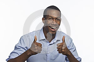 Young African American man giving thumbs up, horizontal