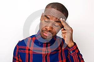 Young african american man with headache and fingers pressing against head