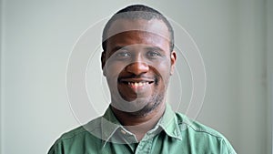 Young African American man listening to music and having break during working day in office spbas.