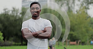 Young african american man look at camera smiling after traning outdoors body exercises. Sport healthy lifestyle.