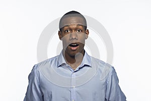 Young African American man looks shocked, horizontal