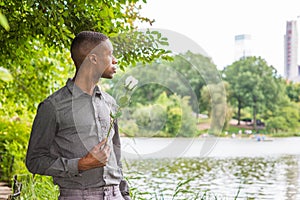 Young African American Man missing you and waiting for you at Central Park in New York