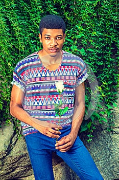 Young African American Man missing you with white rose, thinking