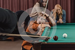 young african american man playing in pool at bar