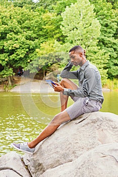 Young African American Man relaxing at Central Park in New York