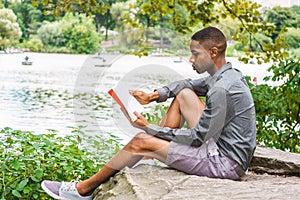 Young African American Man relaxing at Central Park in New York