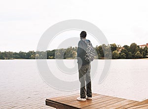 Young African American Man relaxing at Park near lake.