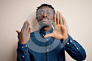 Young african american man showing golden marriage ring on finger over white background with open hand doing stop sign with