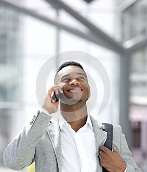 Young african american man smiling with mobile phone