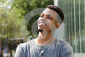 Young african american man smiling outside