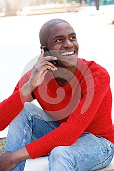 Young african american man smiling talking on mobile.
