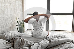 Young African American man stretching after wake up