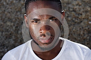 Young african american man with sweat dripping down face