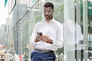 Young African American Man texting on cell phone, traveling in N